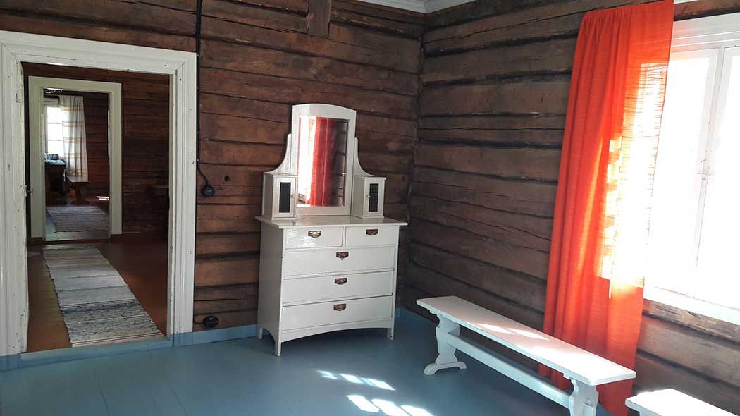 An old dresser in the living room of the hut. The entrance to the living room is next to the dresser where you can see other parts of the hut.