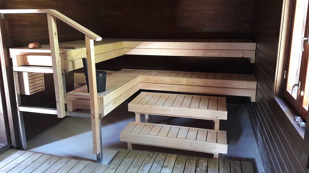 The sauna benches are in good condition inside the sauna.