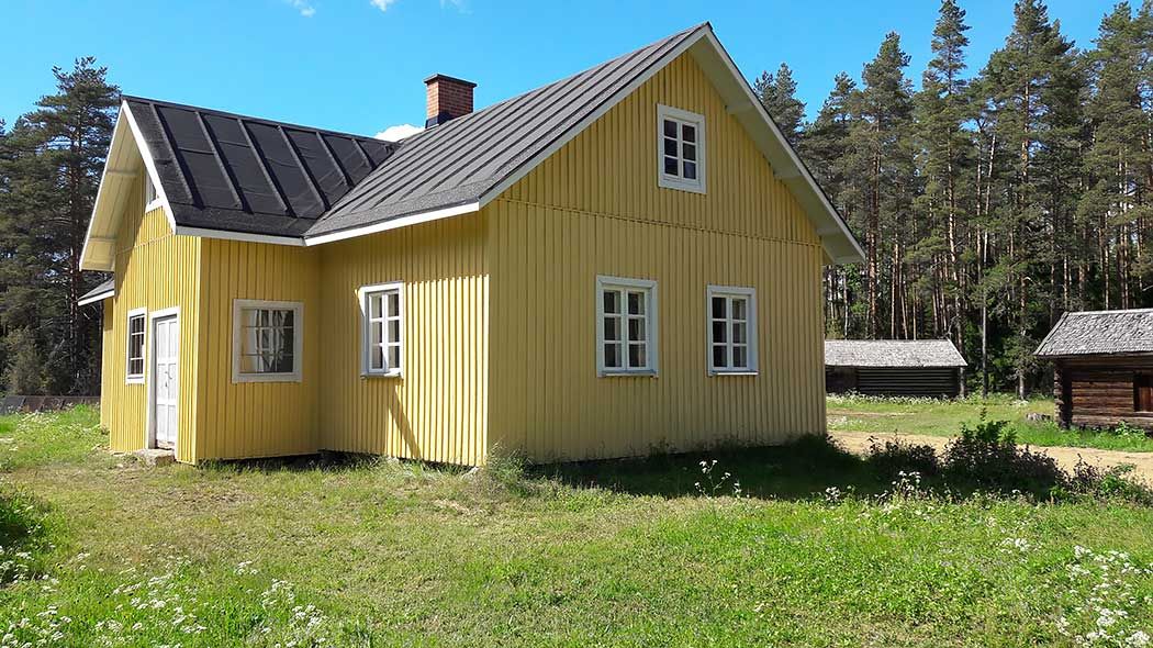 Wooden building and its summery yard area.