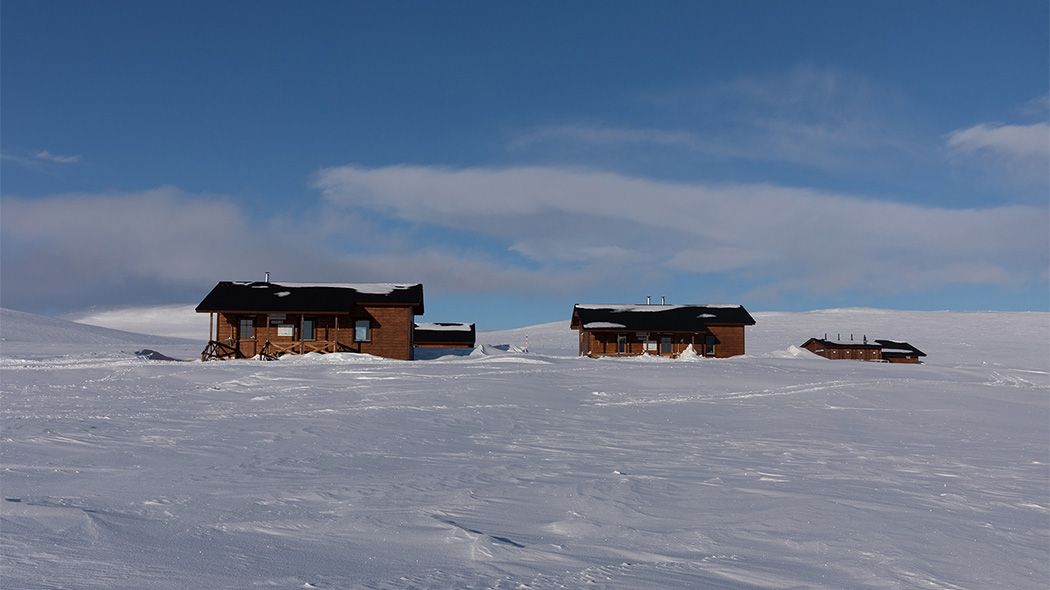 Two huts in the snow.