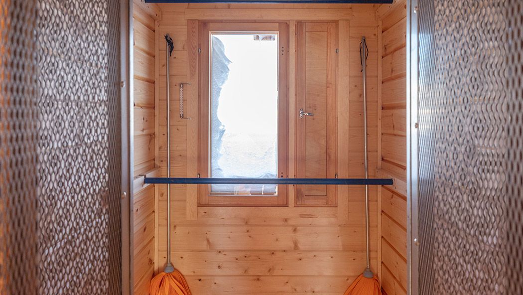 The drying room has a bar and a window.