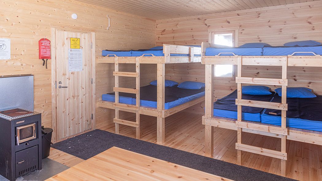 The room has a fireplace and bunk beds.