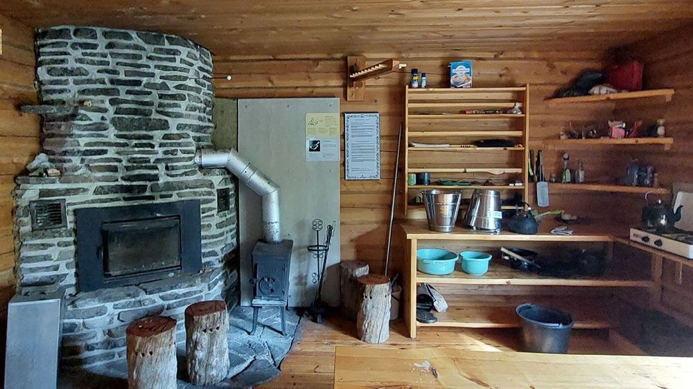 The fireplace and the kitchen corner can be seen in the background.